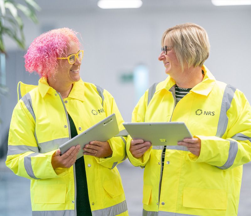 NRS workers in high vis jackets discussing a project